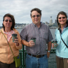 Paul with co-workers Shelly and Bonnie enjoying a cup of Seattle coffee while riding the Ferry.  We were on the way to Olympic National Forest to survey off-highway vehicle trails.  - Fran Smith