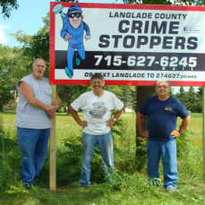 Don and friends putting up a Langlade Co. Crime Stoppers sign in August 2013 - Kevin Schramke