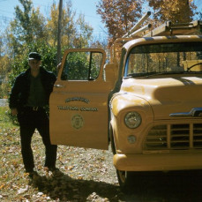 John with work truck, Pelican Lake, 1957. - Bradley Funeral Home