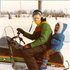 The Hodson family members were our great neighbors in west Ames.   We have many, many fun memories of activities with the two families.  Found this photo from about 1983 when Harold gave our daughter, Amy, a ride on his snowmobile.   - Doris Mohr