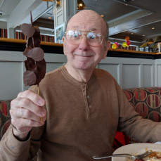 One of my favorite recent pics of John. It captures his love for life and the simple joys. On his 80th birthday. Chocolate covered  - Colette Glenn