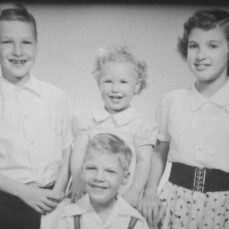 This was Meg when she still had two front teeth.
L to R:  David, Marilyn, Margaret (back); Ken (front)
Kansas, c. 1954 - Marilyn Gesch