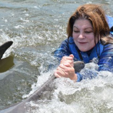 Karen with her beloved dolphins - Carolyn Oakley